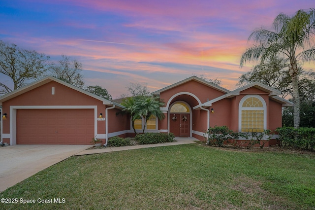 single story home with a yard and a garage