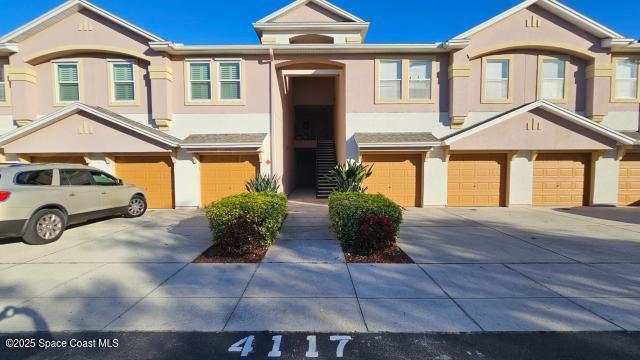 multi unit property featuring a garage