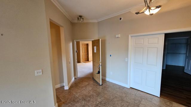 unfurnished bedroom with a closet and ornamental molding