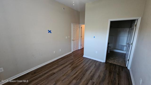 unfurnished bedroom featuring dark hardwood / wood-style floors