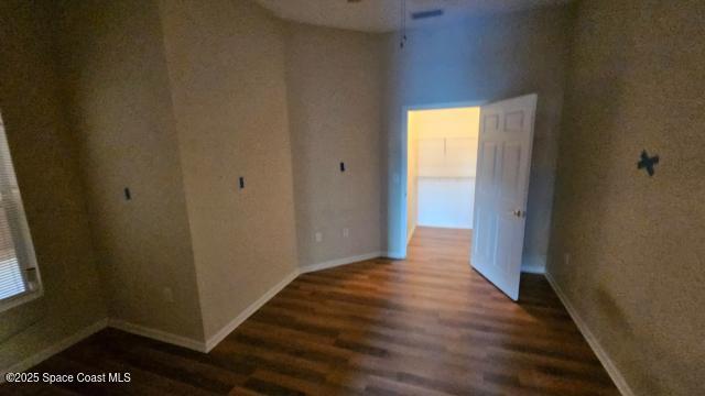 empty room with dark wood-type flooring