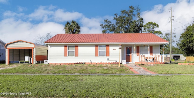 single story home featuring covered porch, a front lawn, and a carport