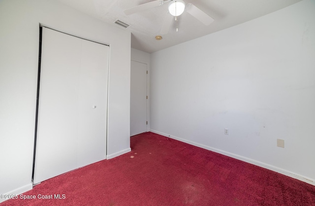 unfurnished bedroom featuring ceiling fan, a closet, and carpet