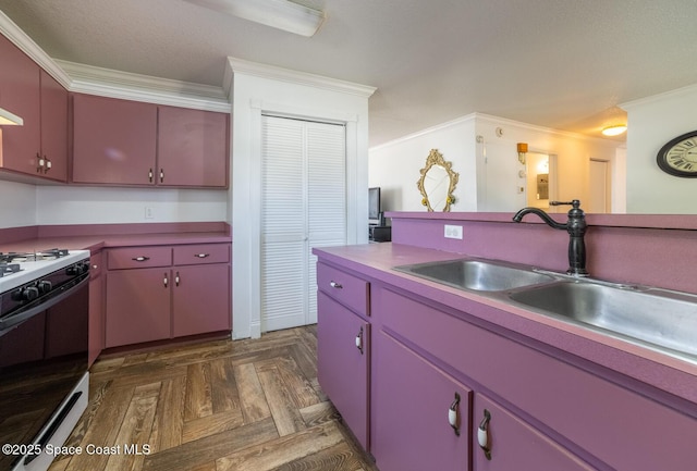 kitchen featuring sink, gas range oven, crown molding, and dark parquet floors