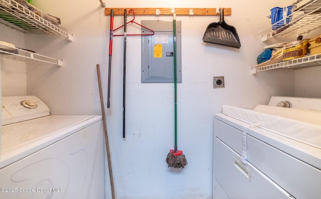 clothes washing area featuring washing machine and clothes dryer and electric panel