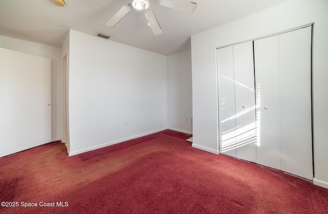 unfurnished bedroom featuring ceiling fan, a closet, and carpet flooring