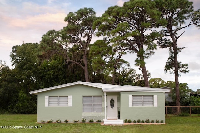 ranch-style house with a yard