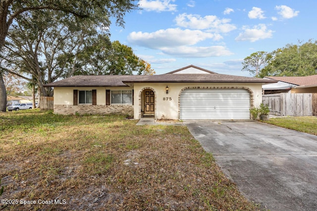 ranch-style home featuring a garage and a front yard