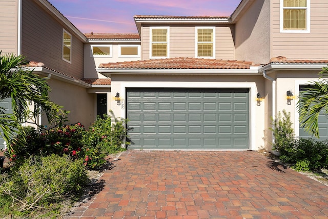 mediterranean / spanish home featuring a garage