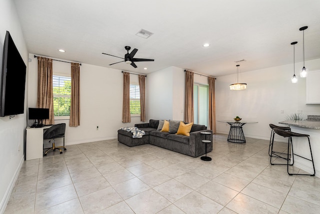 living room featuring ceiling fan and light tile patterned floors