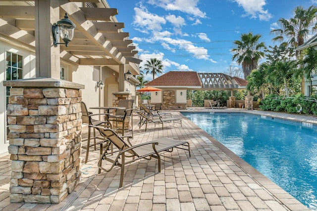 view of pool with a pergola and a patio