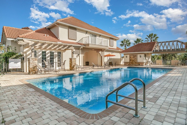 view of swimming pool featuring an outbuilding and a patio