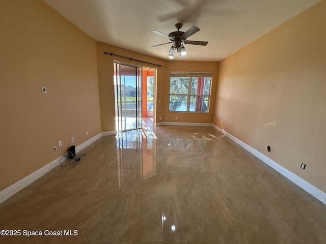 unfurnished room with ceiling fan