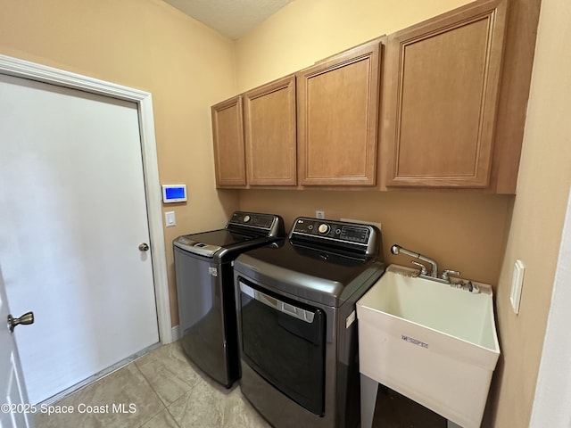 washroom featuring cabinets, sink, and separate washer and dryer