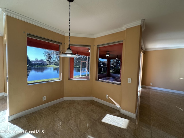 unfurnished dining area featuring a wealth of natural light, crown molding, and a water view