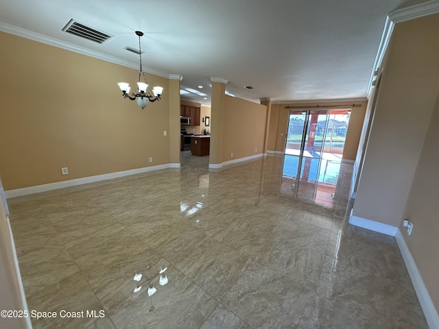 spare room featuring an inviting chandelier and ornamental molding