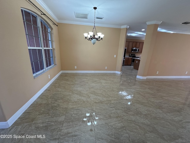 unfurnished dining area with ornamental molding and an inviting chandelier