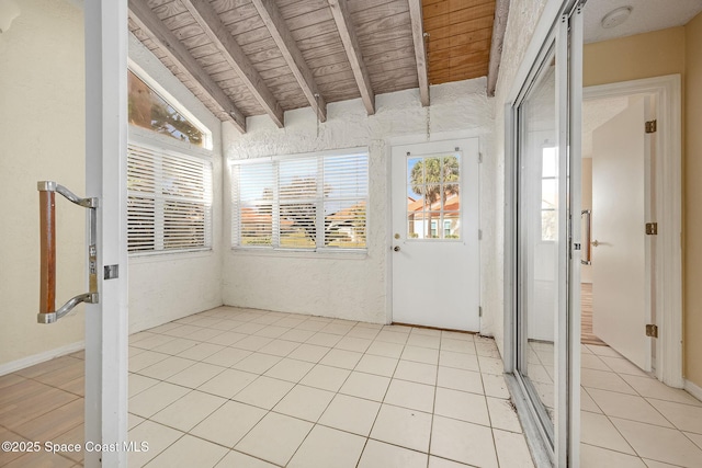 unfurnished sunroom featuring lofted ceiling with beams and wood ceiling