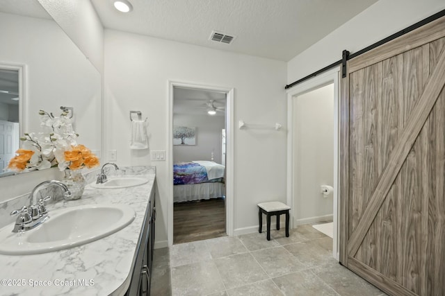 bathroom featuring vanity and a textured ceiling