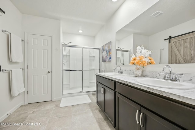 bathroom with vanity and a shower with shower door