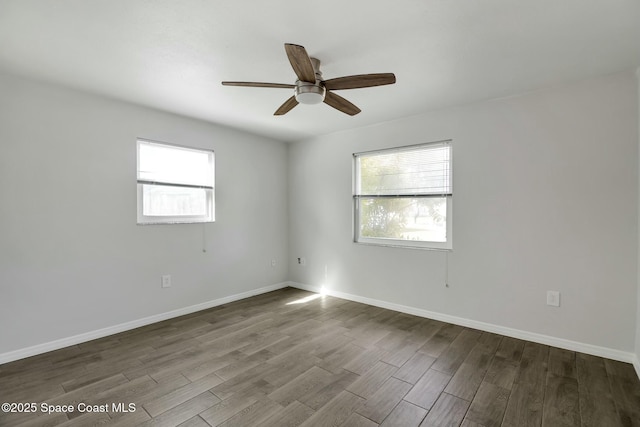 empty room with hardwood / wood-style floors and ceiling fan