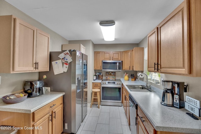 kitchen featuring light brown cabinets, sink, and appliances with stainless steel finishes