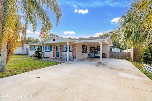 view of front of house with a front lawn, a porch, and a carport