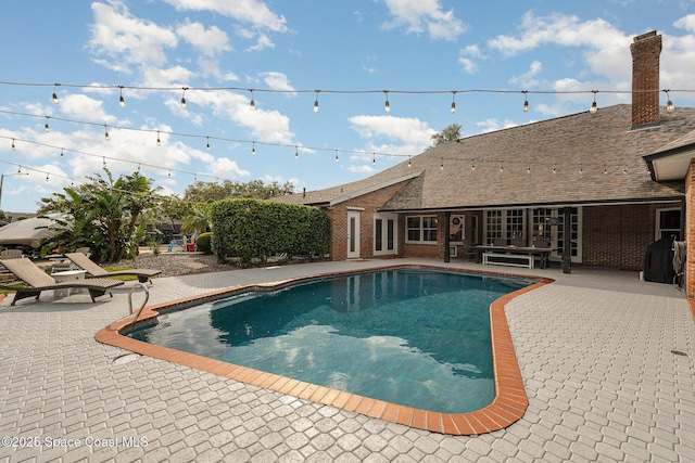 view of swimming pool featuring a patio area