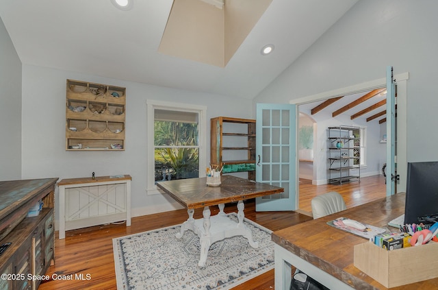 office area with hardwood / wood-style flooring, vaulted ceiling with beams, and french doors