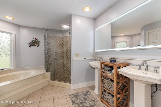 bathroom featuring tile patterned flooring, shower with separate bathtub, and sink