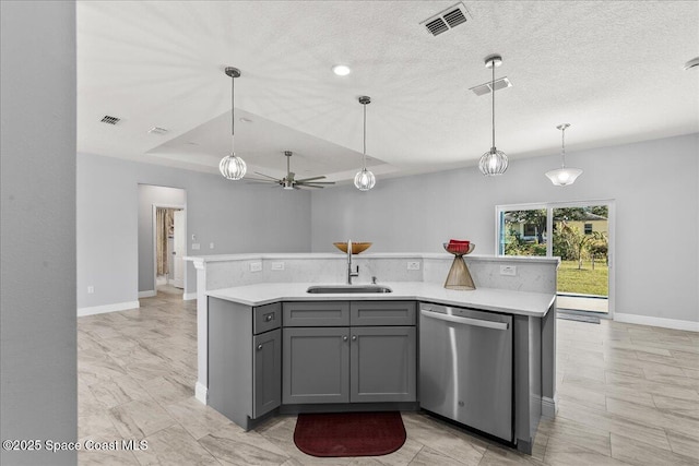 kitchen featuring stainless steel dishwasher, sink, gray cabinetry, and a kitchen island with sink