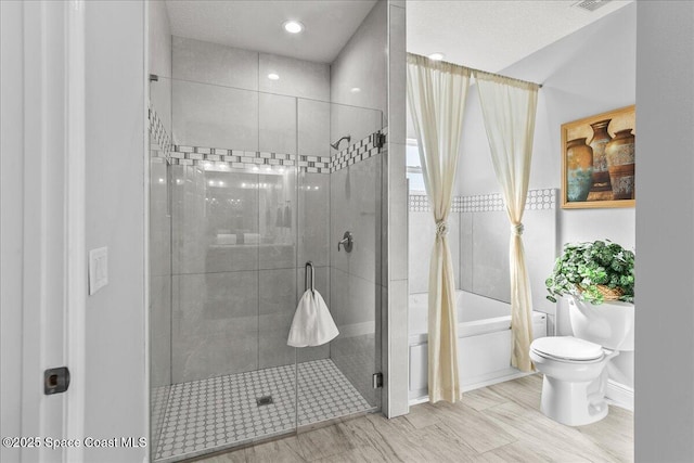 bathroom with shower with separate bathtub and toilet