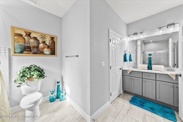 bathroom with vanity, a textured ceiling, toilet, and a shower with door