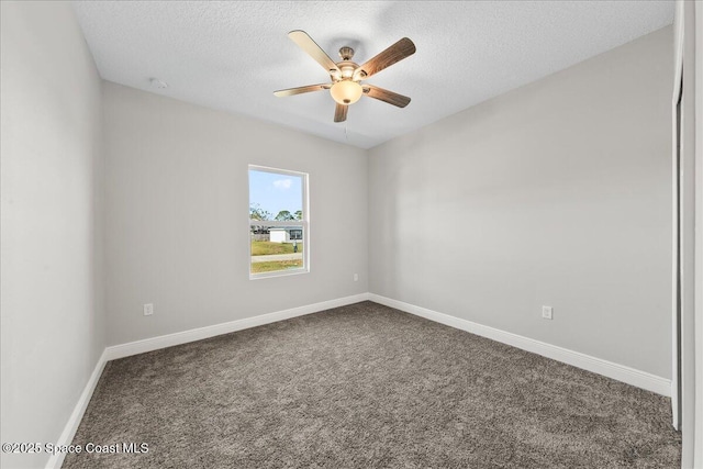 carpeted spare room with ceiling fan and a textured ceiling