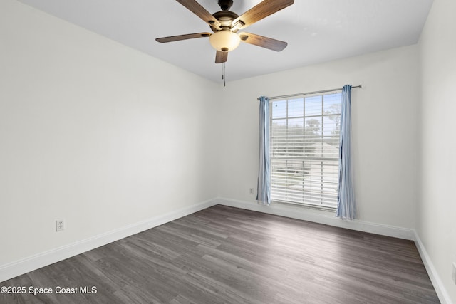 spare room with dark wood-type flooring and ceiling fan