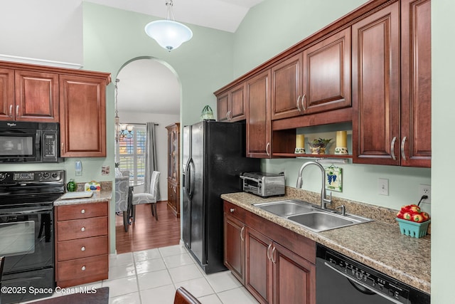 kitchen featuring sink, black appliances, light tile patterned floors, a notable chandelier, and hanging light fixtures