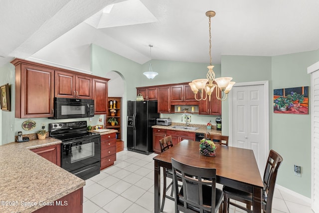 kitchen featuring light tile patterned floors, decorative light fixtures, vaulted ceiling, and black appliances