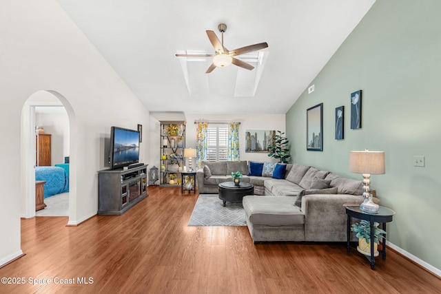 living room featuring lofted ceiling, ceiling fan, and wood-type flooring