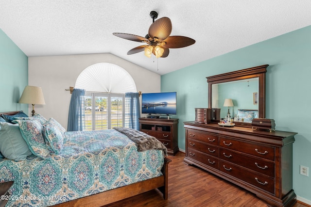 bedroom featuring a textured ceiling, dark hardwood / wood-style flooring, ceiling fan, and lofted ceiling