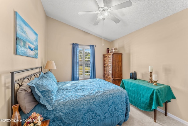 bedroom with light carpet, a textured ceiling, vaulted ceiling, and ceiling fan