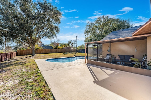 view of pool with a patio area, a sunroom, and a yard