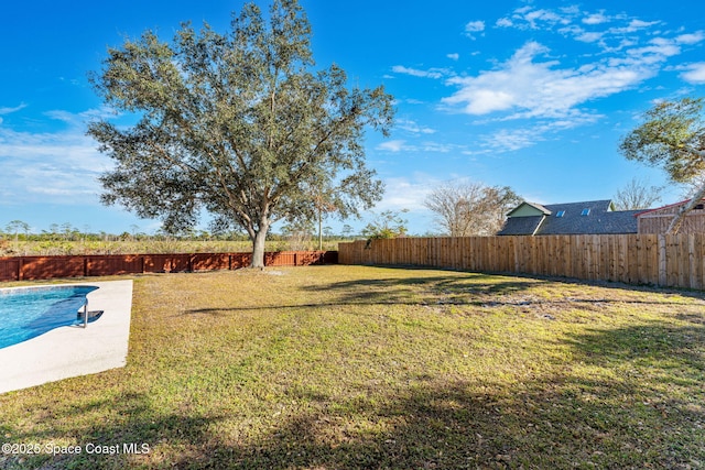 view of yard with a fenced in pool