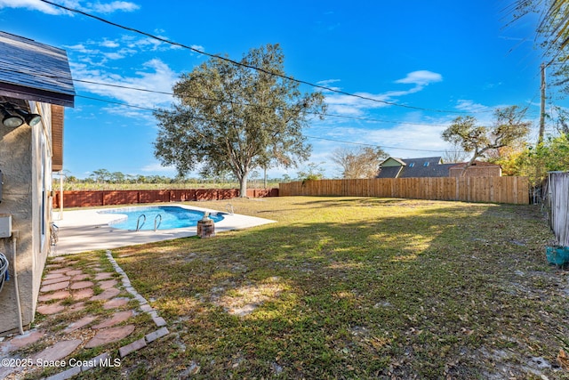 view of yard featuring a patio area and a fenced in pool