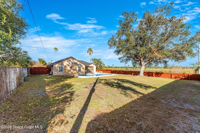 view of yard with a fenced in pool