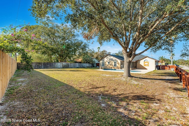 view of yard with a fenced in pool and a patio area