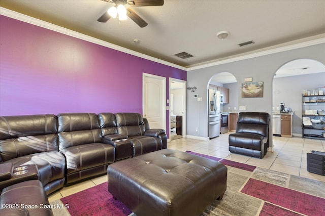 living room with light tile patterned floors, ceiling fan, and crown molding