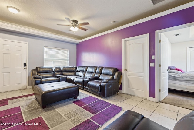 tiled living room with a textured ceiling, ceiling fan, and crown molding