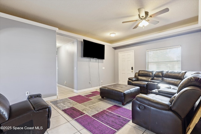 living room with a textured ceiling, ceiling fan, light tile patterned floors, and crown molding