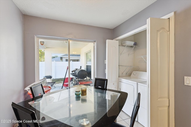 dining room with separate washer and dryer and light tile patterned floors