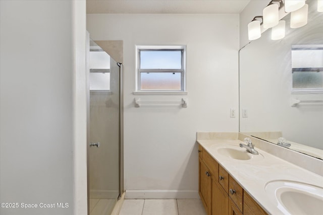 bathroom with tile patterned flooring, vanity, and a shower with door